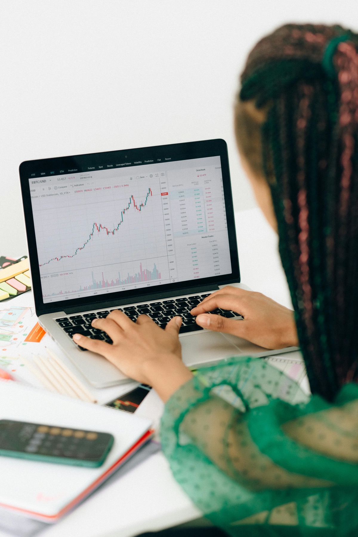 Investor reviewing market charts on a laptop