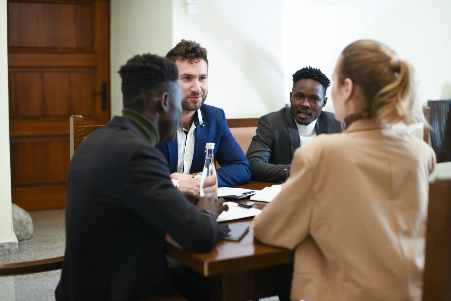 Investment team discussing strategy around a table